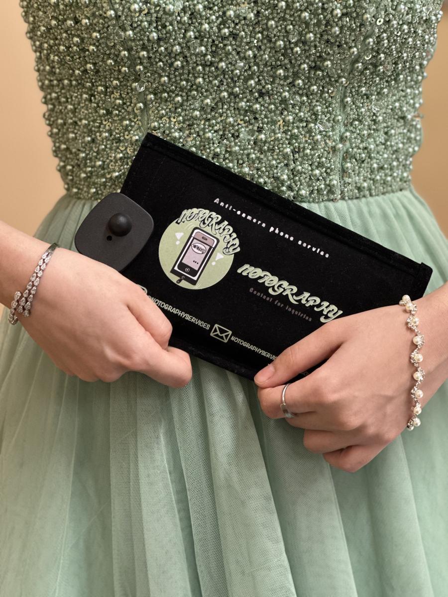 Guest holding a Notography anti-camera phone case at a wedding in the Washington DC area